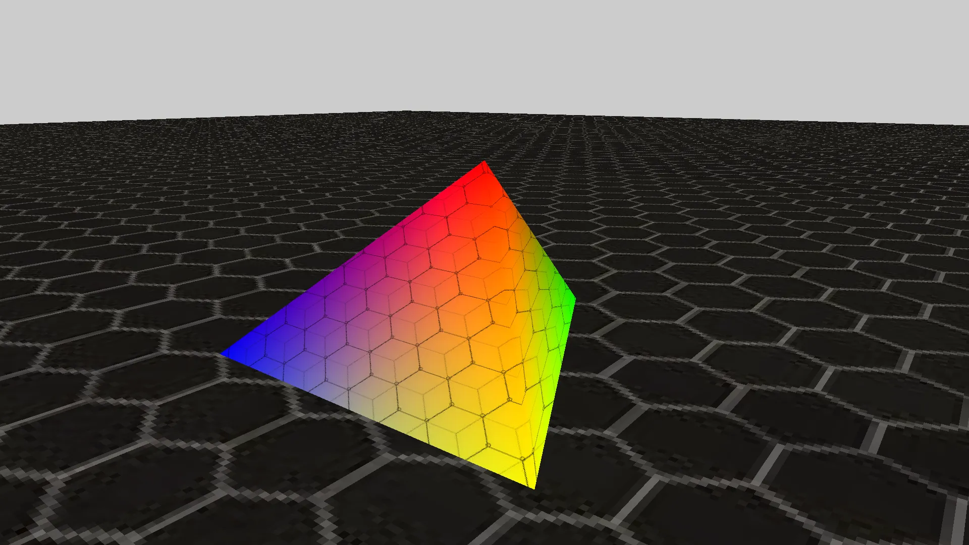 The first thing on screen: a hex-textured tetrahedron with red, green, blue and yellow corners on a gray floor